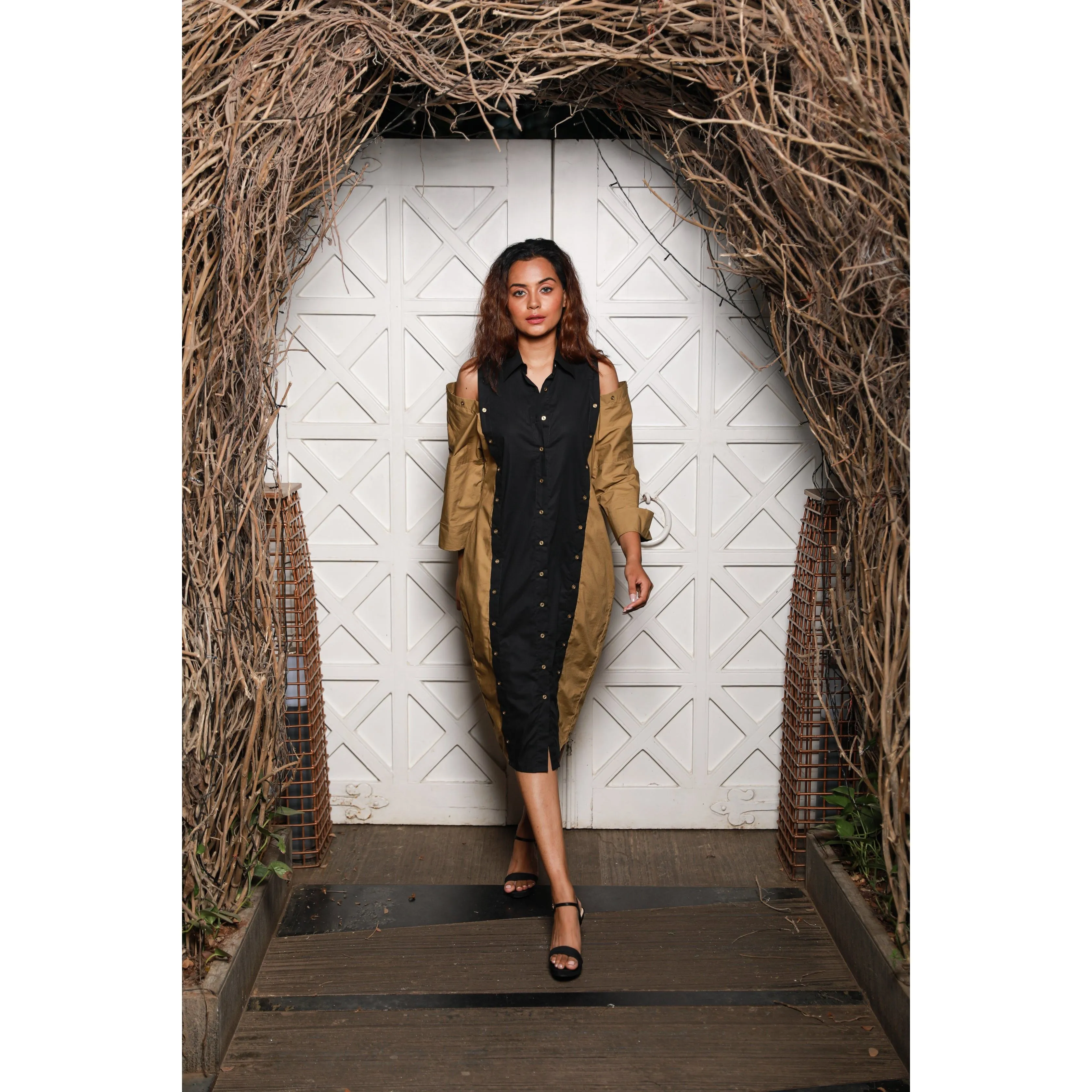 Two-toned  shirt dress features khaki and black vertical panels with cold shoulders.