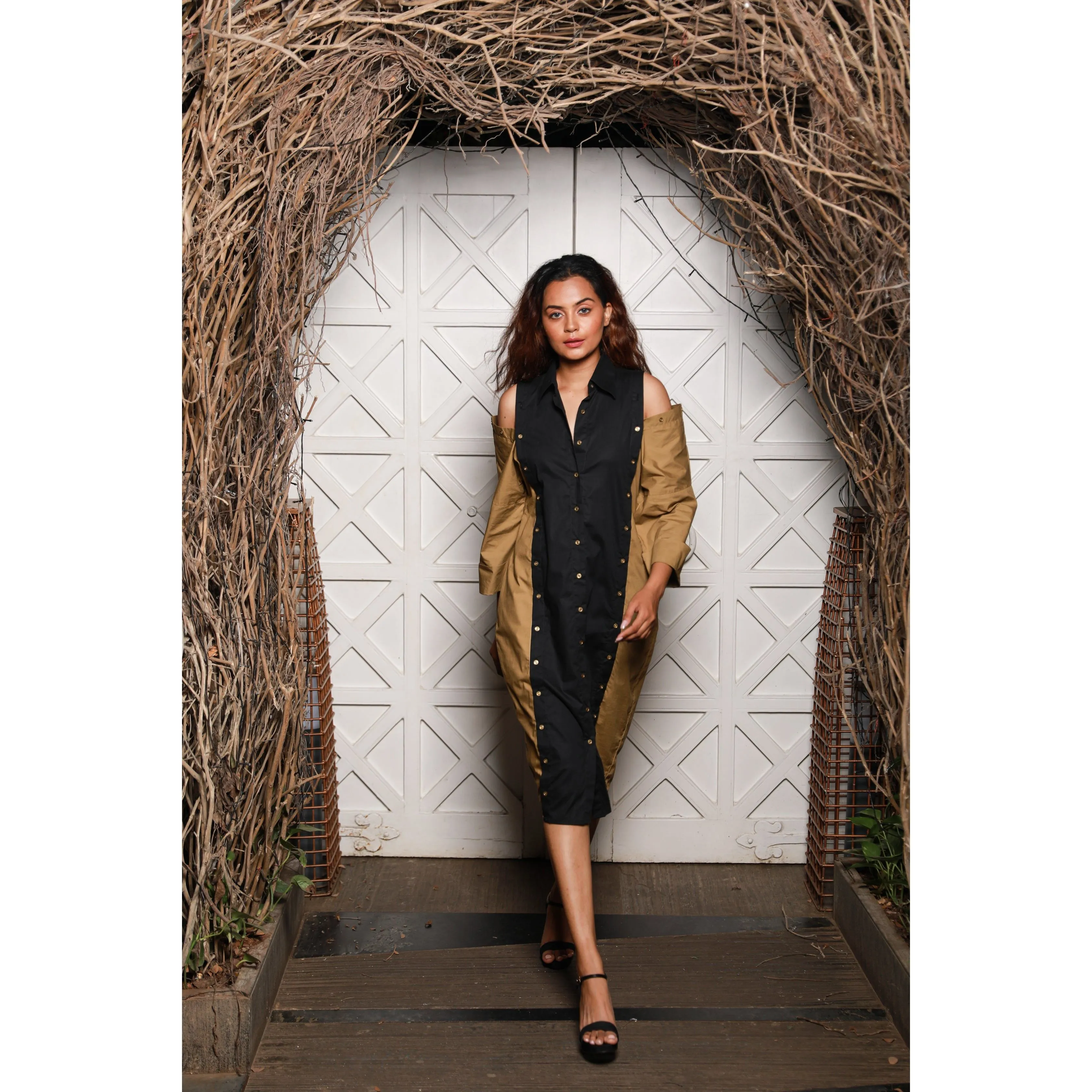 Two-toned  shirt dress features khaki and black vertical panels with cold shoulders.